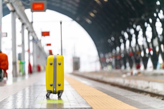 a yellow piece of luggage sitting on top of a tiled floor