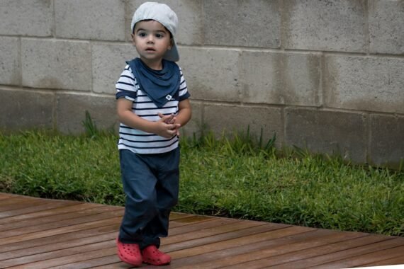 a child standing on a wood deck